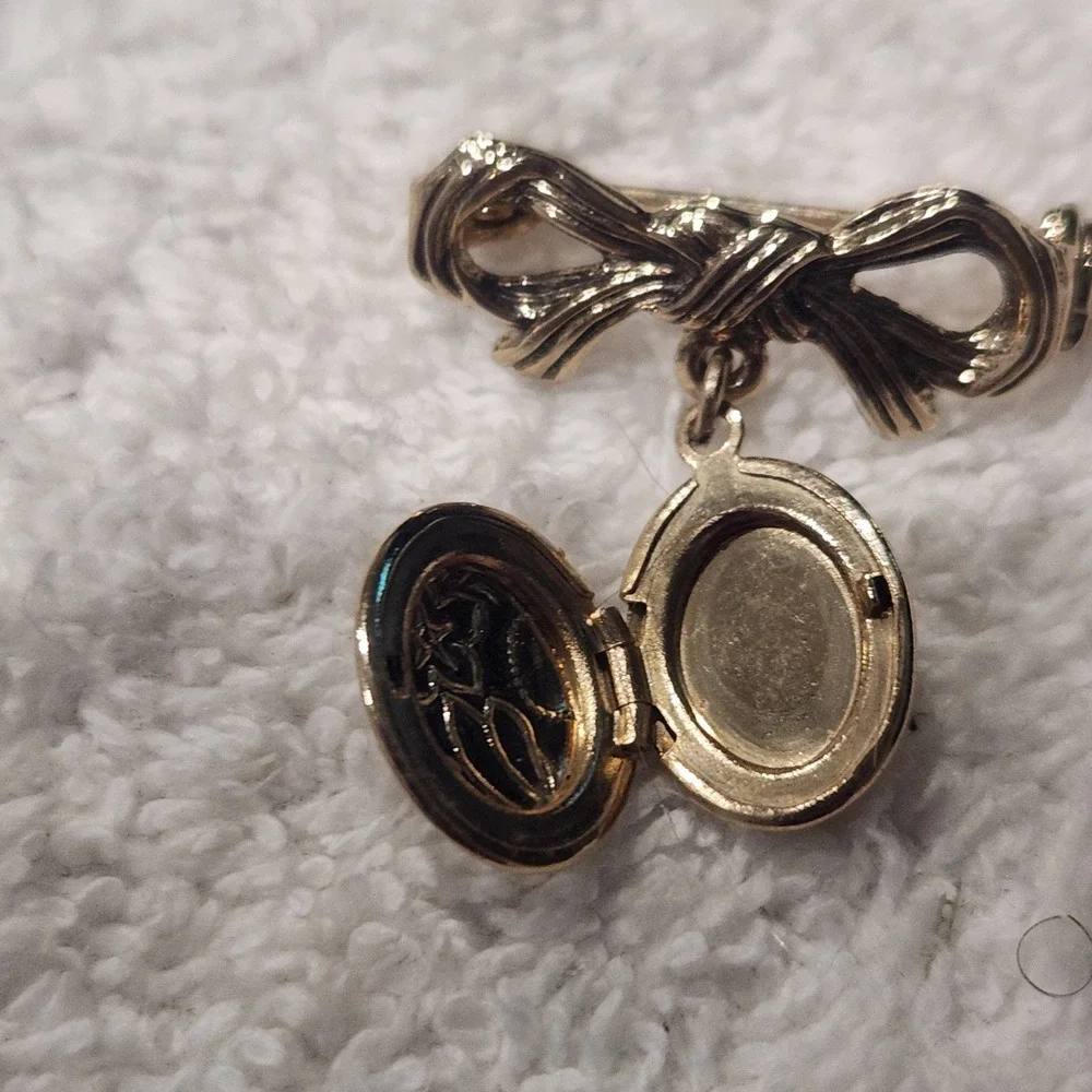 Vintage Gold Tone Bow Brooch with Engraved Floral Oval Dangle Locket Pin